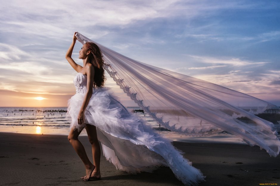Девушка в свадебном платье на море